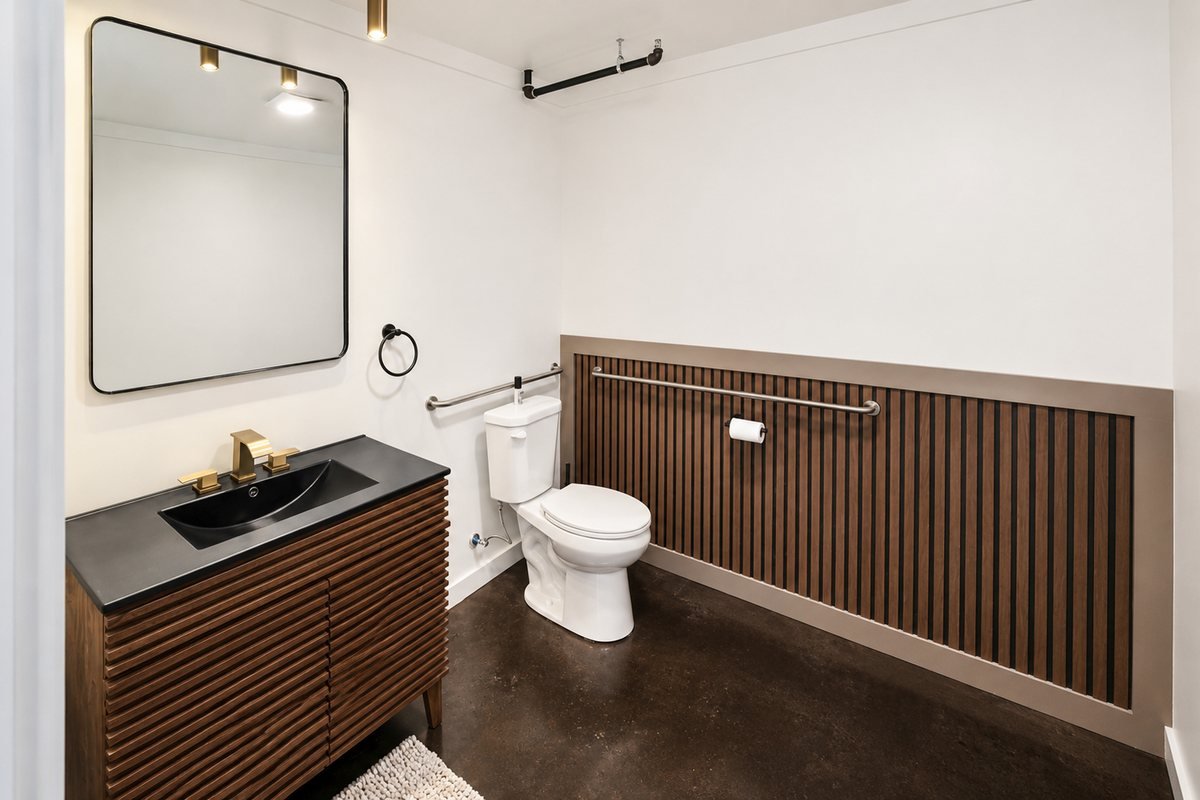 Suite restroom with walnut slat vanity
